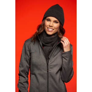 A woman is wearing a grey ribbed beanie and matching scarf, with a dark jacket against a red background.