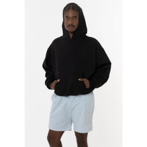 A model wearing a black mineral wash fleece wide hoodie paired with light grey shorts, featuring a logo.