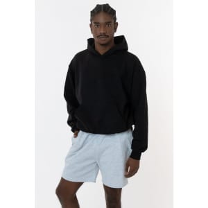 A black Mineral Wash Fleece Wide Hoodie displayed on a model wearing grey shorts. The hoodie features a logo.