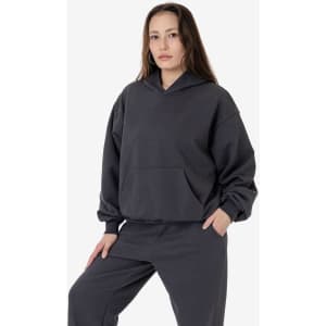A woman wearing a dark grey Mineral Wash Fleece Wide Hoodie, featuring a hood and front pocket.