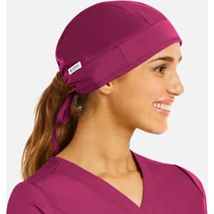 A unisex scrub cap in vibrant magenta, featuring a back tie for a secure fit and a small logo.