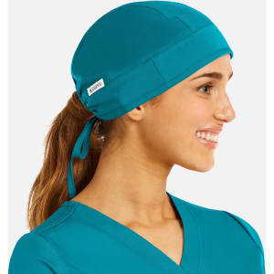 A unisex scrub cap in vibrant teal, featuring a logo and a tie for secure fitting.