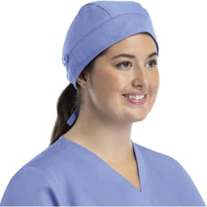 A unisex scrub cap in light blue with buttons, worn by a smiling woman, featuring a stylish design.