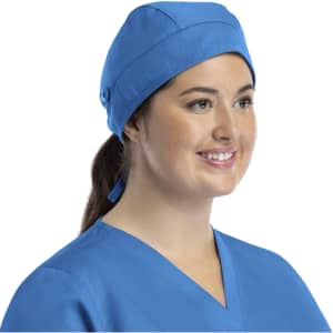 A unisex scrub cap in blue, featuring buttons and worn by a smiling individual.