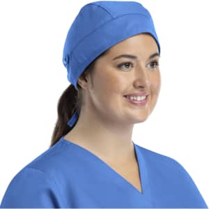 A unisex blue scrub cap with buttons, worn by a woman smiling, set against a plain background.