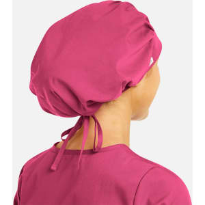 A unisex bouffant scrub cap in vibrant pink, featuring a gathered design and adjustable ties at the back.