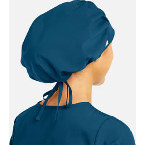 A unisex bouffant scrub cap in dark teal, styled with a gathered design and adjustable ties at the back.