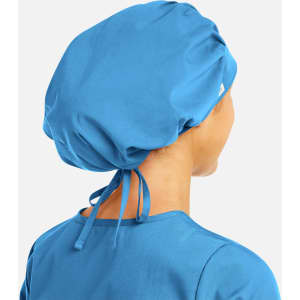 A unisex bouffant cap in blue, featuring a gathered design and adjustable ties at the back.
