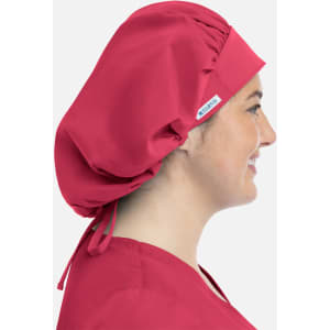 A unisex bouffant cap in vibrant red worn by a smiling individual, featuring a logo on the side.