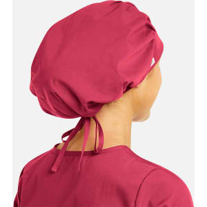 A unisex bouffant scrub cap in a deep pink colour, featuring a gathered design and adjustable ties at the back.