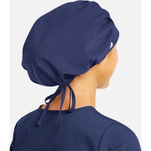 A unisex bouffant scrub cap in navy blue with a tie-back design, featuring a logo. Suitable for medical uniforms.