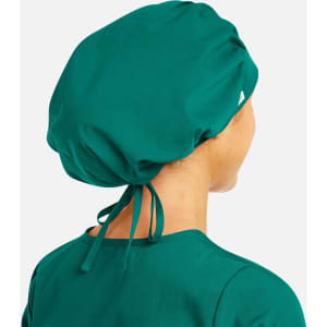 A unisex bouffant scrub cap in a vibrant teal colour, featuring a logo and adjustable ties at the back.