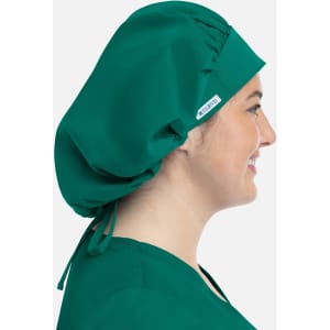 A green unisex bouffant scrub cap is displayed on a model, featuring a simple design and an adjustable tie.