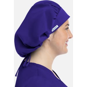 A unisex bouffant cap in purple, featuring a gathering at the back and a side logo.