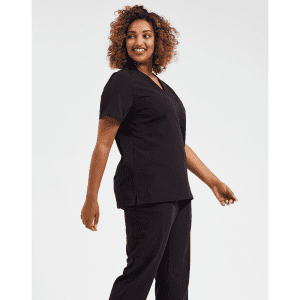A model wearing a black women's tunic, featuring a V-neck and relaxed fit, alongside matching black pants.