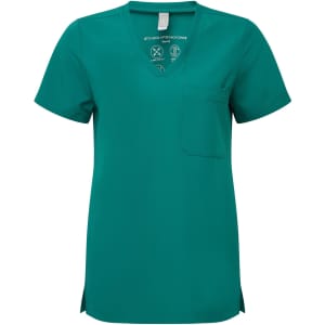 A teal women's tunic with a V-neck, short sleeves, and a chest pocket, featuring a logo on the inside tag.