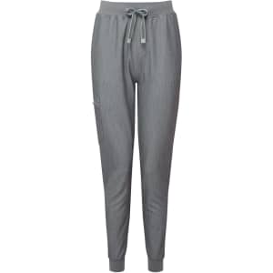 A pair of women's jogger pants in grey, featuring an elastic waistband and a drawstring. The design includes a side pocket and logo.
