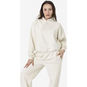 A cream-coloured plush fleece pullover hoodie with a hood and side pockets, styled with matching bottoms.