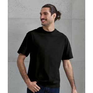 An oversized black T-shirt displayed on a smiling man, featuring a simple design and short sleeves.