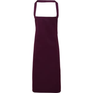 A deep burgundy organic cotton bib apron with adjustable neck straps and no visible logos.