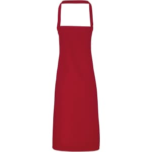 A red organic cotton bib apron featuring a simple design and adjustable straps. It has a logo on it.