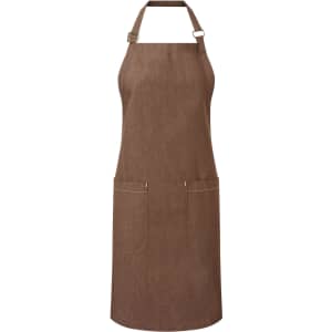 A brown organic denim bib apron featuring adjustable straps and two front pockets, with a logo on the side.