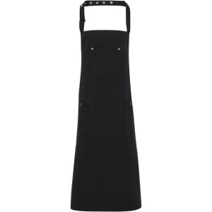 A black Chino cotton bib apron with adjustable straps and a front pocket. It includes a logo on the front.