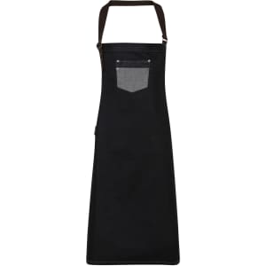 A black denim bib apron featuring a contrasting grey pocket and a logo, with adjustable straps.