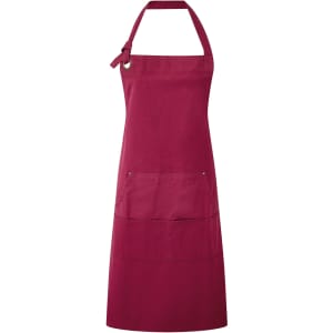 A burgundy heavy cotton canvas pocket apron with an adjustable neck strap and a front pocket. It has a logo.