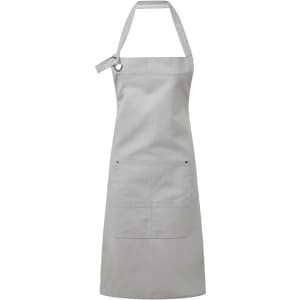 A grey heavy cotton canvas pocket apron featuring adjustable straps and a front pocket. It has a logo.