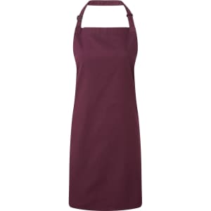 A maroon bib apron with an adjustable neck strap, designed for chefwear, featuring a logo.