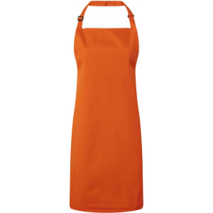 An orange bib apron with a neck strap and adjustable features, featuring a logo. Ideal for chefwear.