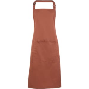 A rust-coloured bib apron with a pocket, featuring an adjustable neck strap and a logo.