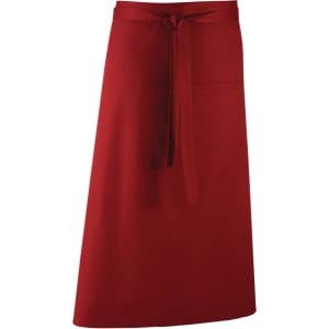 A red apron featuring a waist tie and a front pocket, suitable for workwear use. It has a logo on it.