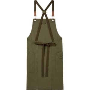 A cross-back bib apron in olive green with pockets and adjustable straps. Features a logo on the strap.