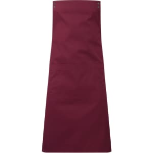 A maroon apron with a split design and pocket features, includes metal snaps and a smooth finish.