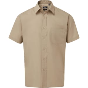 A short-sleeved button-up shirt in a beige colour, featuring a front pocket and a logo.