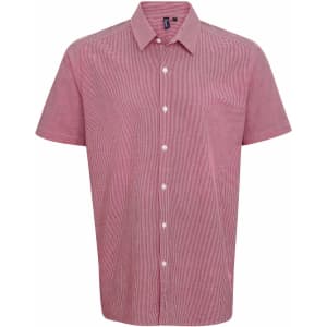 A short-sleeve button-up shirt in a microcheck pattern, featuring shades of red and white, with a logo on the left.
