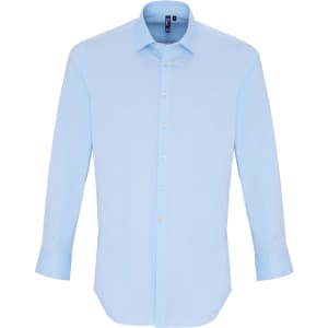 A light blue button-up shirt with long sleeves, featuring a collar and a logo.