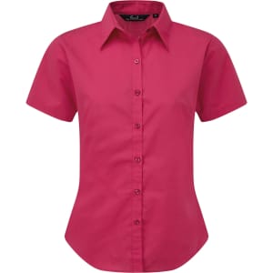 A short-sleeved button-up shirt in bright pink, featuring a classic collar and a fitted design. It has a logo on the side.
