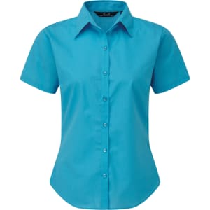 A short-sleeved button-up shirt in bright turquoise, featuring a collar and front buttons. Includes a logo.