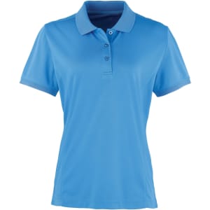 A blue women's polo shirt with a collared design, featuring buttons and short sleeves. It has a logo on it.