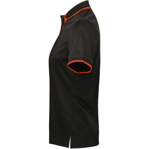 A women's polo shirt featuring a black body with orange contrast details and a modern cut. It has a logo displayed.