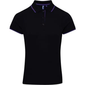 A women's black polo shirt featuring contrast purple trim and a logo on the chest. Short sleeves and a classic collar.