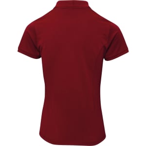 A red women's polo shirt with a classic collar, featuring a fitted design and short sleeves. It has a logo on it.