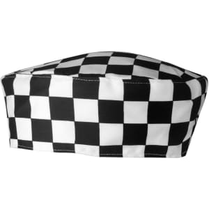 A chef's skull cap featuring a black and white checkered pattern. It has a rounded shape and is made from fabric.