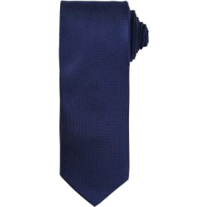 A navy blue micro waffle tie with a textured pattern and a rolled end. It features a logo.