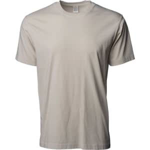 A light beige Premium Pigment Dye T-Shirt displayed on a plain background. It features a logo on the label.