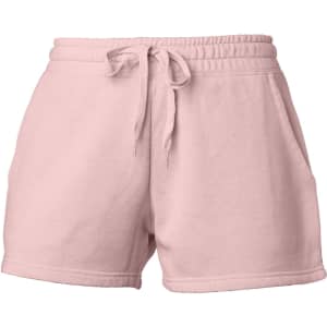 A pair of women's sweatshorts in a soft pink colour, featuring an elastic waistband and pockets.