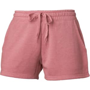 Women's sweatshorts in a soft pink shade with an elastic waistband and side pockets. Features a logo on the design.